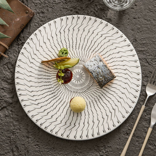 Decorative plate with a dessert on a textured surface with cutlery.