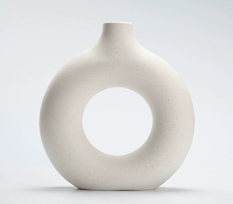 Minimal ceramic vases used for sculptural shelf styling