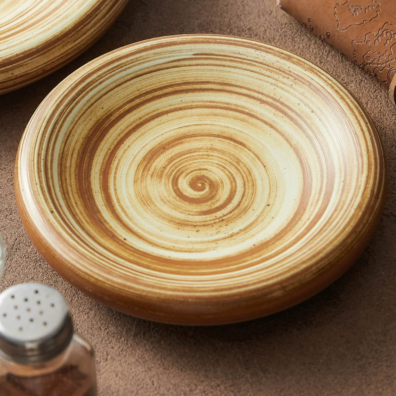 Artistic stoneware dish with concentric spiral design