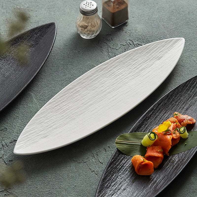 Black leaf-shaped ceramic plate with natural texture