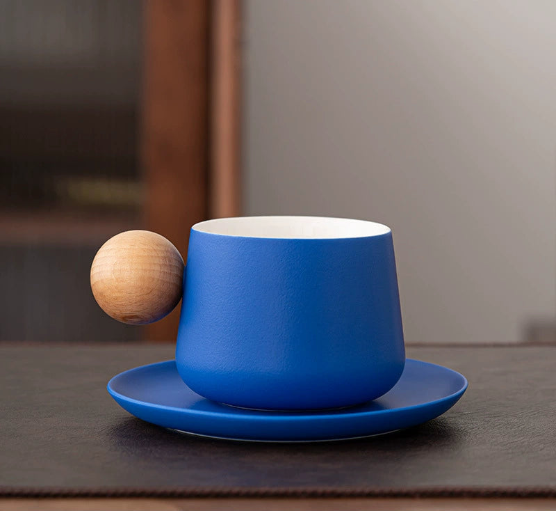 Blue matte ceramic coffee cup on white pedestal