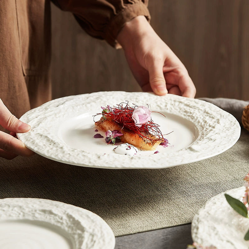 Close-up of artisan ceramic plate with textured border