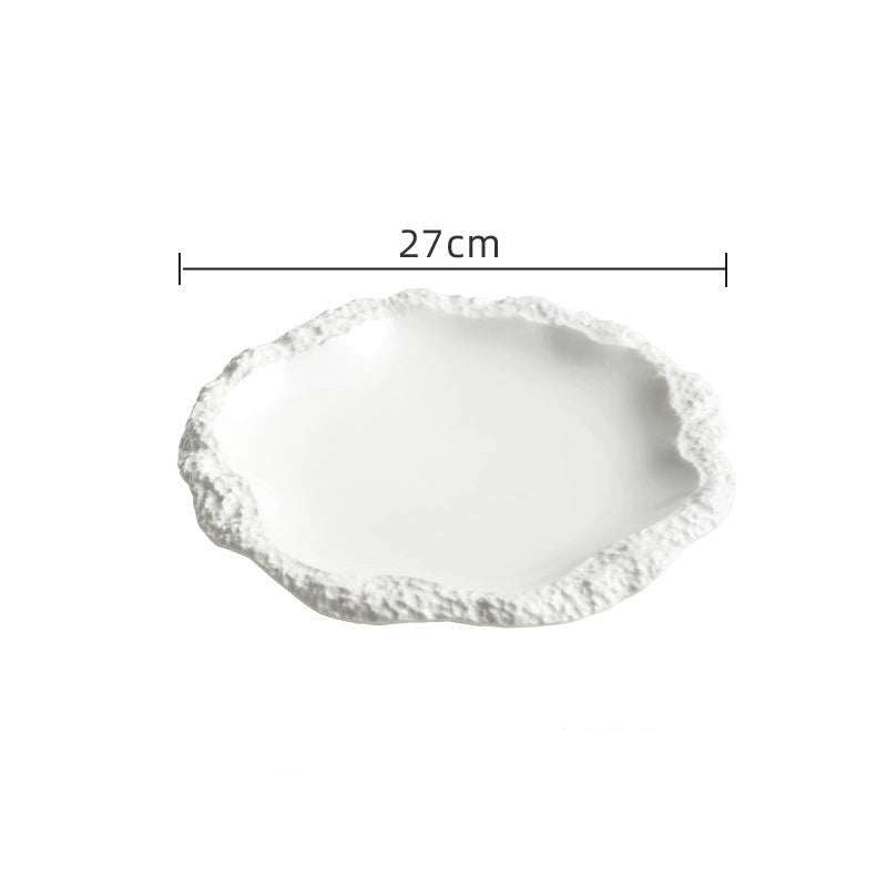 Contemporary ceramic plate styled with wooden utensils