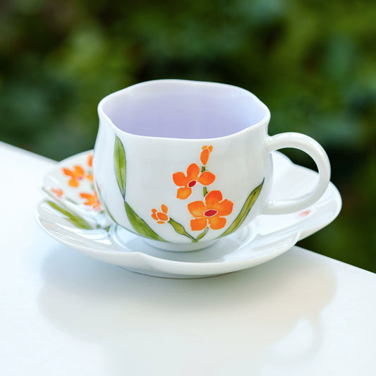 Elegant ceramic floral cup with orange flower design