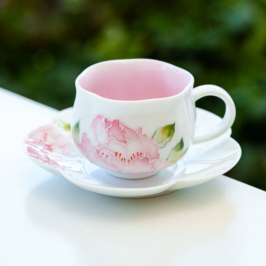 Elegant ceramic floral teacup with petal-shaped saucer