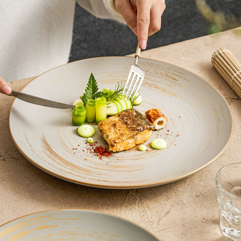Elegant flat ceramic plate with gold brush accents