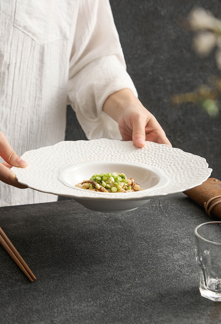 Fine dining dish with deep bowl and wavy outer rim