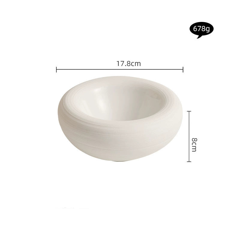 Fine dining setup featuring deep artistic ceramic bowl