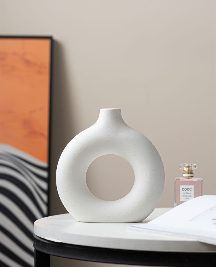 Matte ceramic circular vases styled with abstract wall art