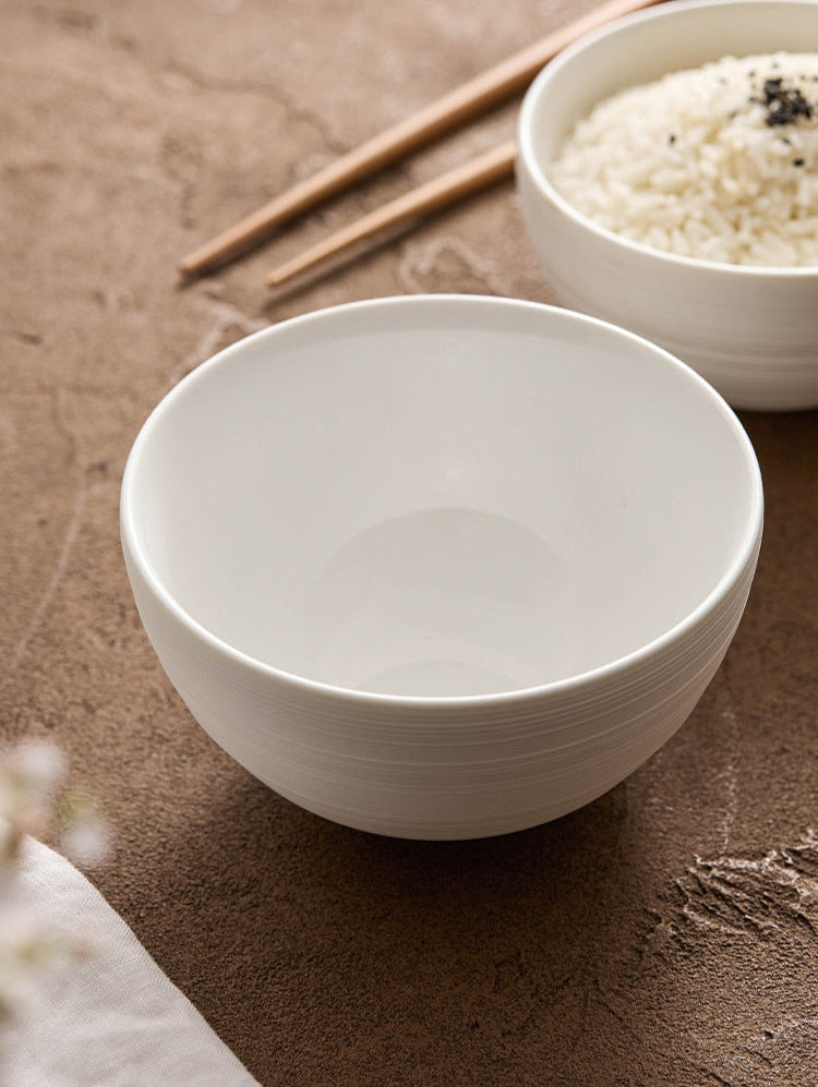 Hand holding minimalist ceramic bowl