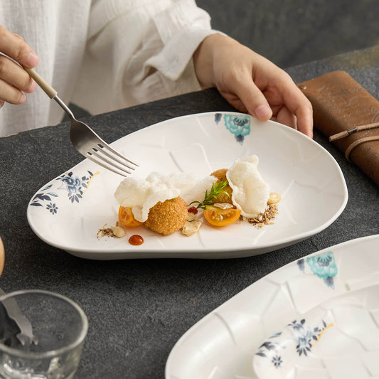 Handcrafted ivory porcelain dish inspired by natural cracked earth.