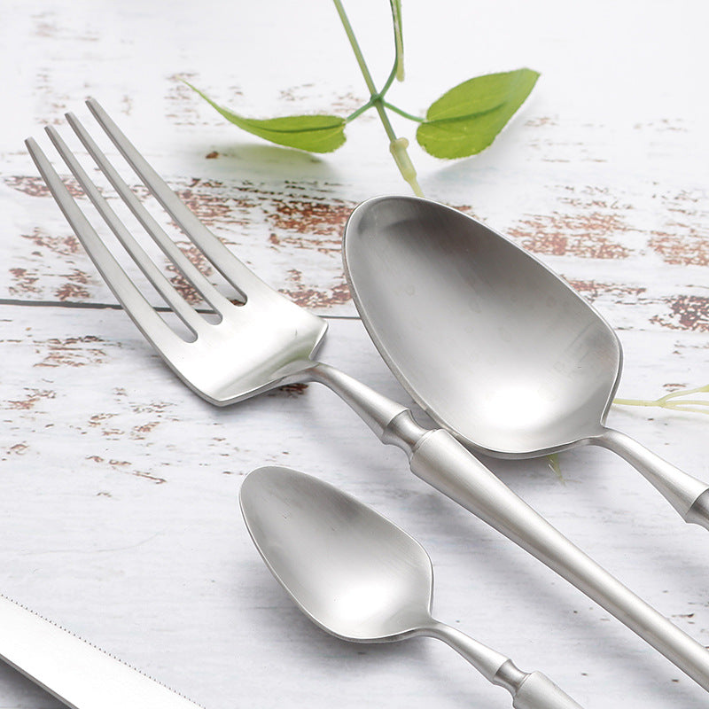 Luxury black gold utensils set on white ceramic plate