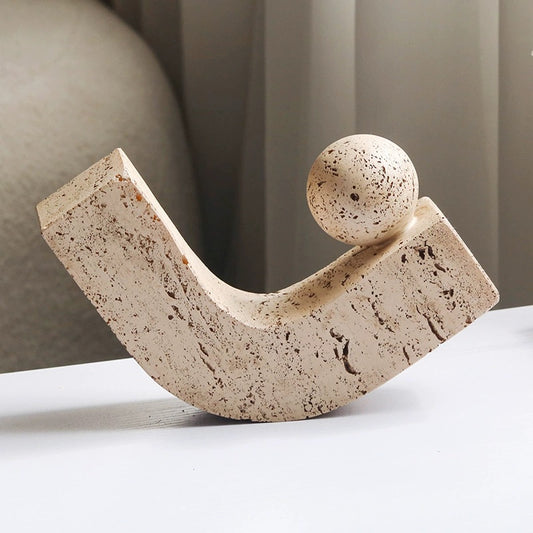 Minimalist abstract stone sculpture with curved arc and sphere design
