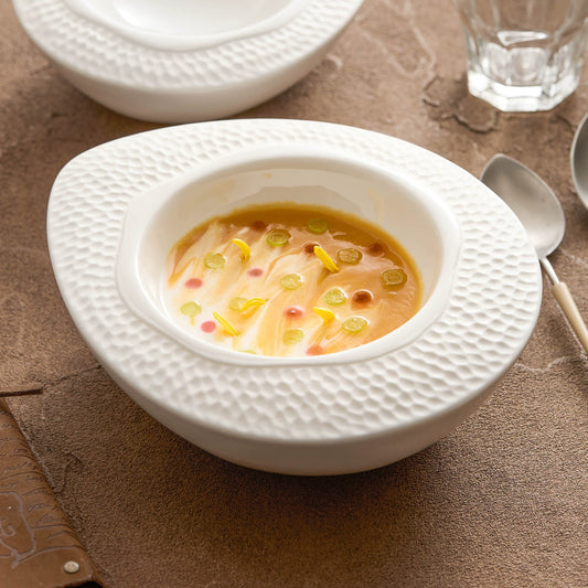 Modern ceramic serving bowl with textured hammered rim