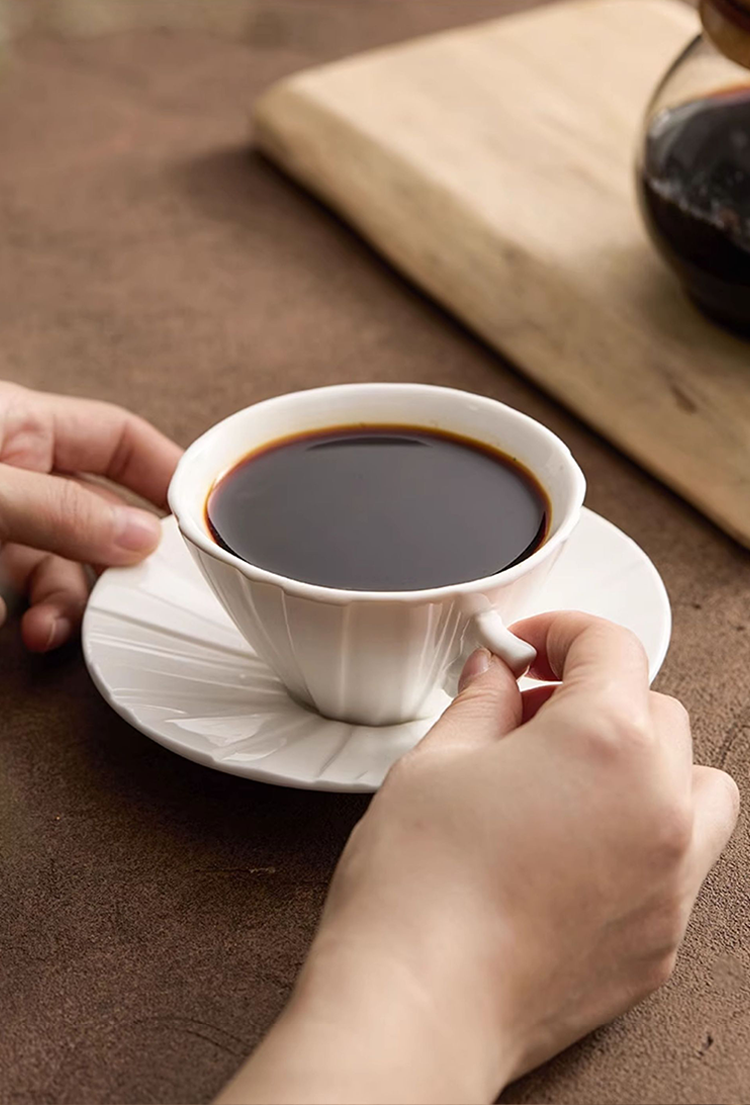 Modern minimalist origami porcelain cup emphasizing quiet luxury.