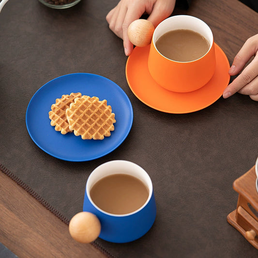 Orange ceramic coffee mug and saucer set