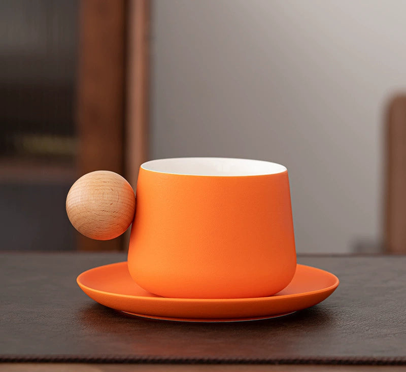 Orange cup and saucer on leather placemat