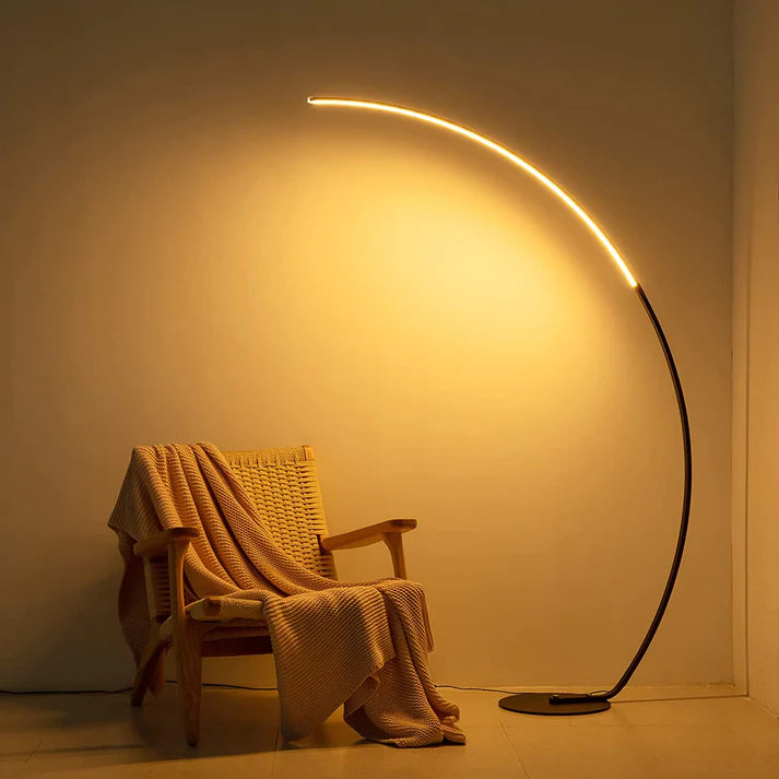 RGBW modern curved floor lamp in a standing position on wooden floor
