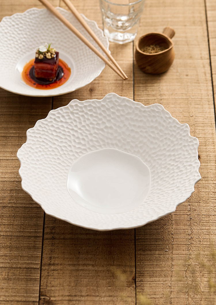 Scalloped rim porcelain dish for modern kitchen and dining presentations.