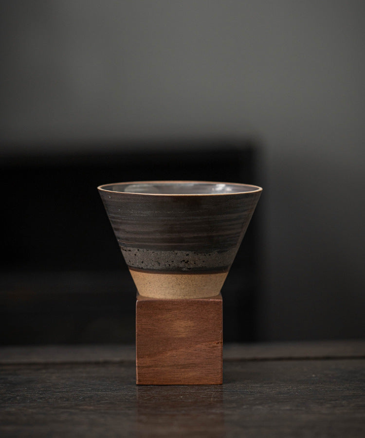 Sculptural ceramic coffee cup and square wood base