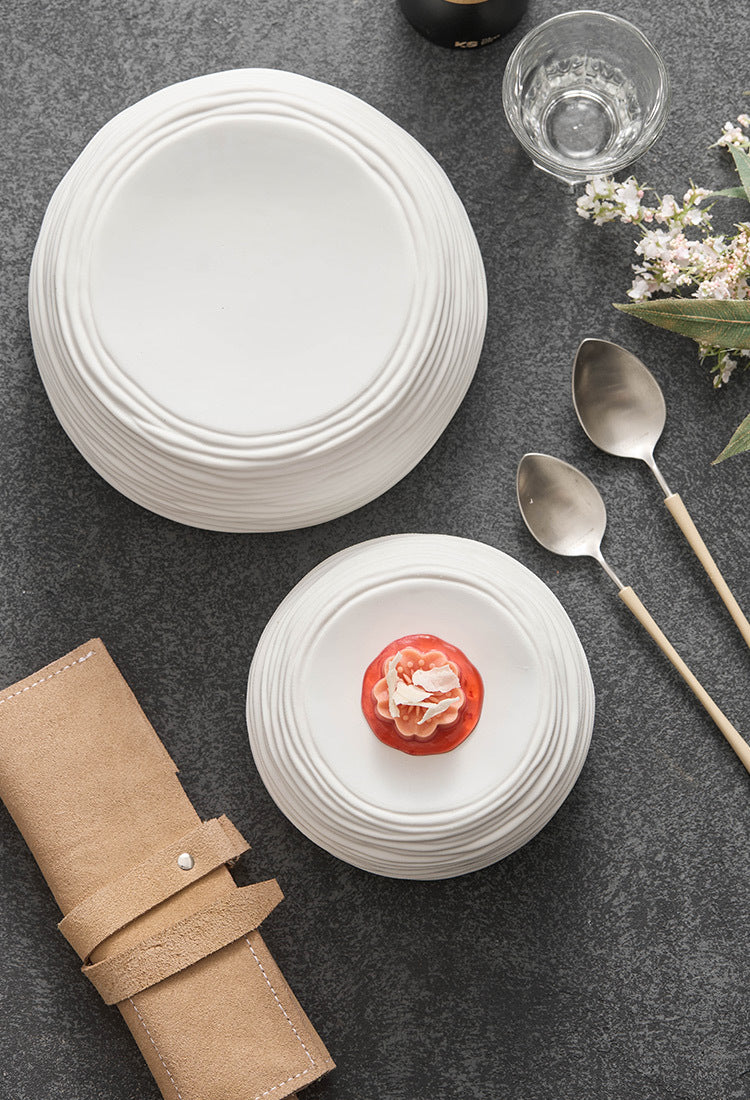 Sculptural ripple design ceramic plate for creative dining