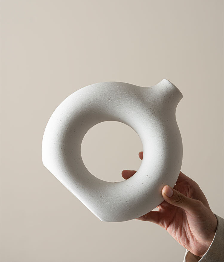 Geometric ceramic art vases with hollow center and curved silhouette