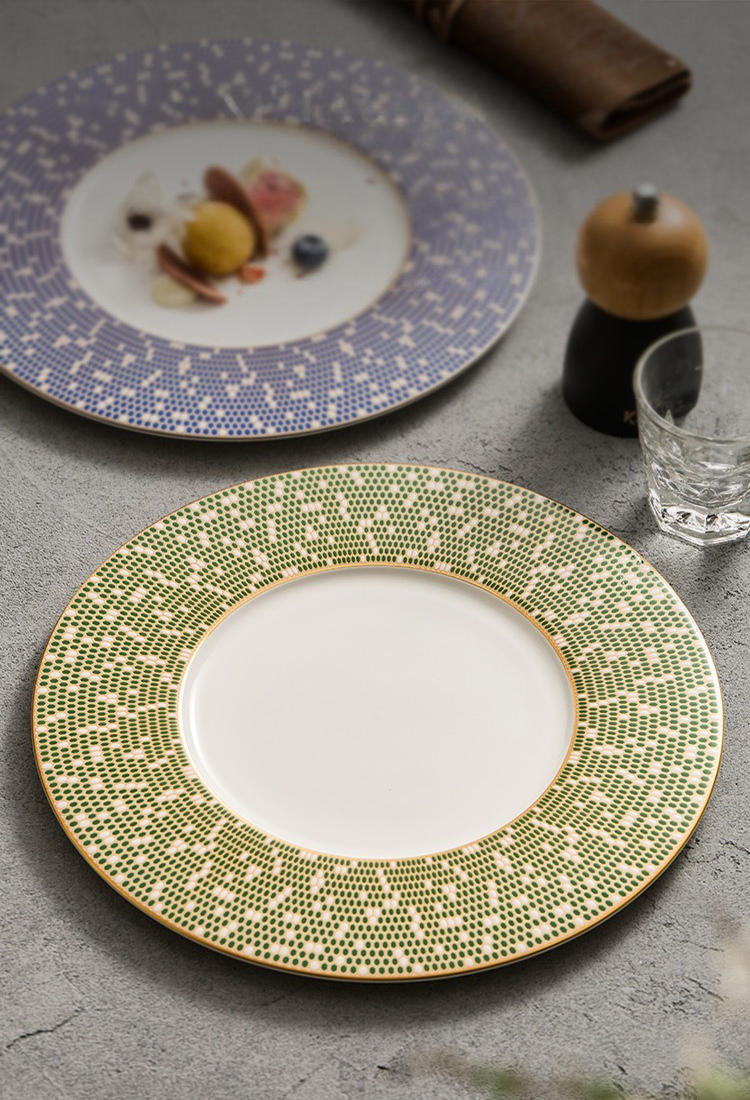 Side view of a Celestial Series plate showing the golden-hued base and slim silhouette.