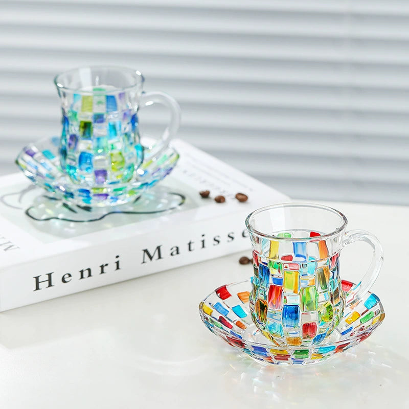 Side view of hand-painted glass coffee mug with saucer