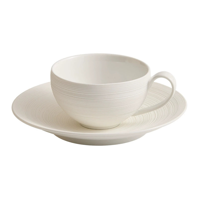 Tactile ceramic cup resting on matching saucer