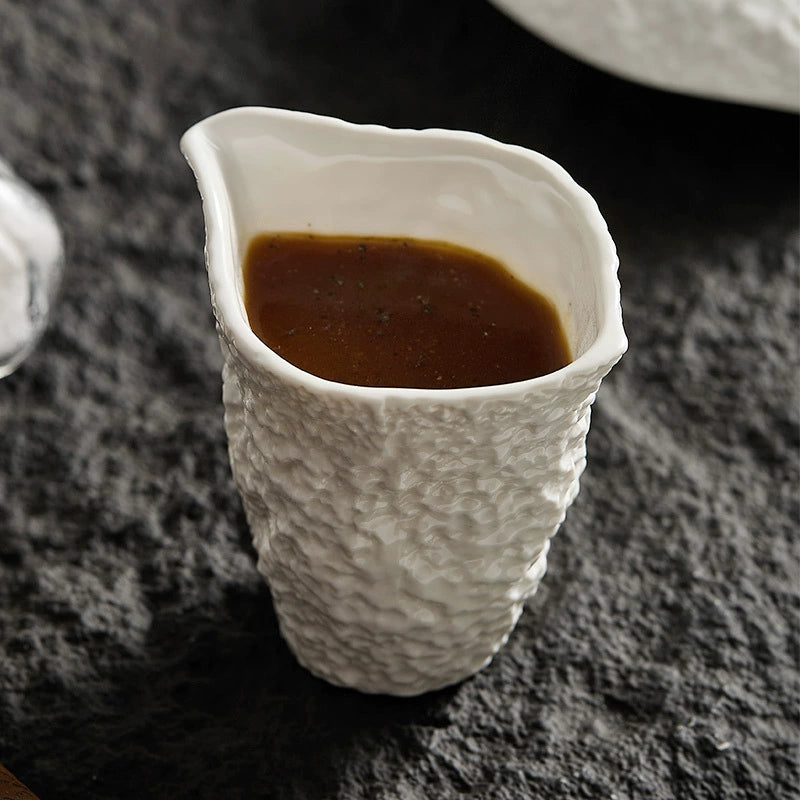 Textured ceramic milk jug with asymmetrical spout
