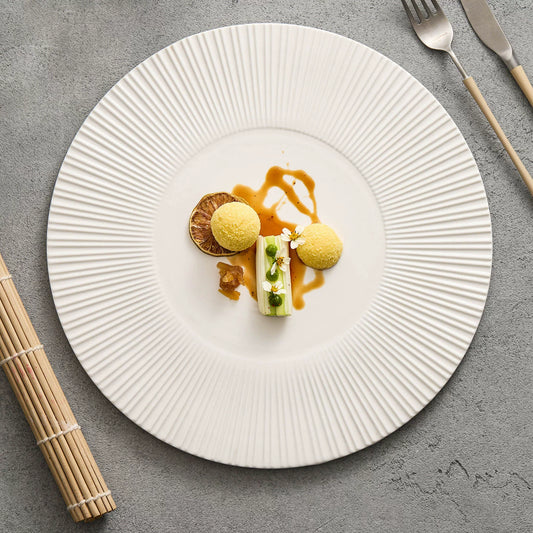 Textured white ceramic service plate for modern fine dining.