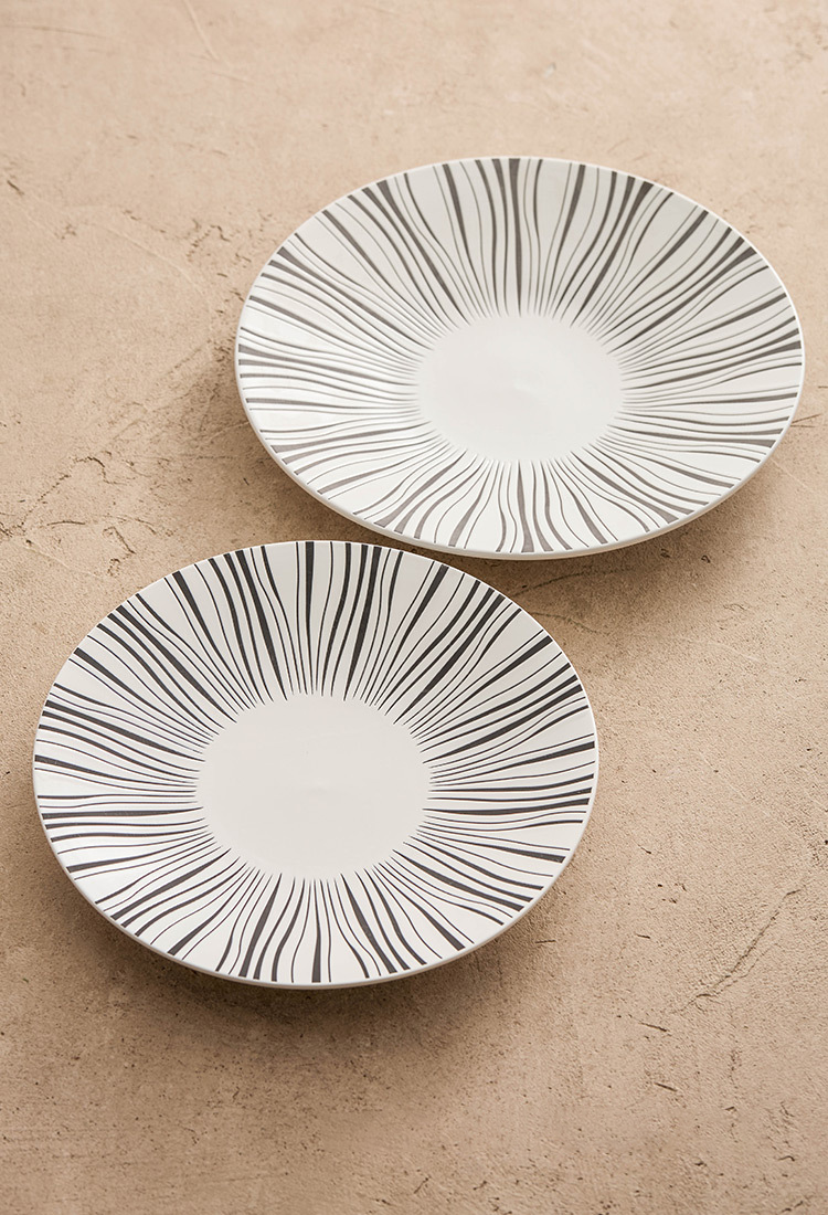 Top-down view of gourmet dish on artistic ceramic plate