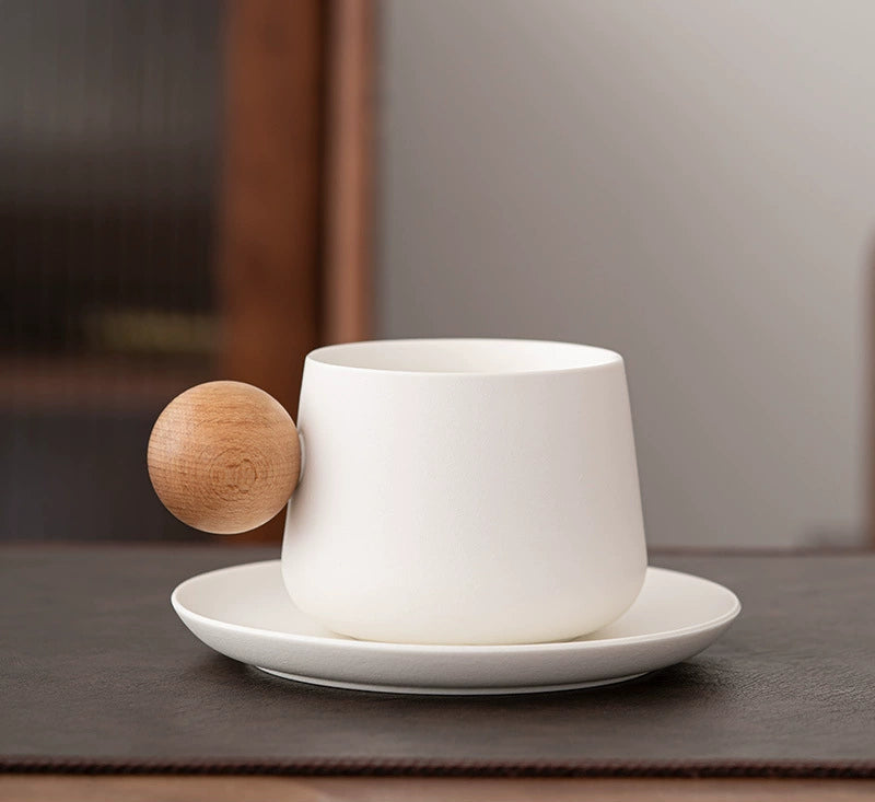 White ceramic mug with round wooden side handle