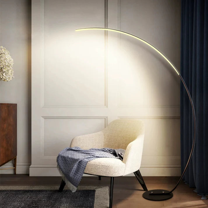 sleek minimalist curved floor lamp glowing in a modern living room