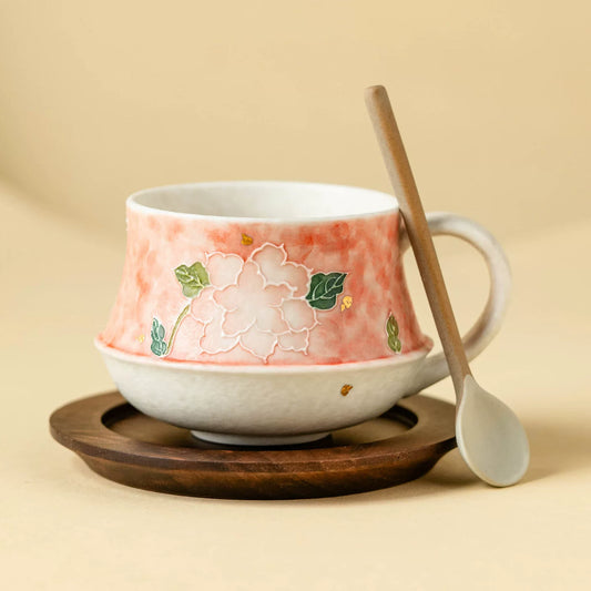 artisanal ceramic tea cup with floral peony motif and gold accents