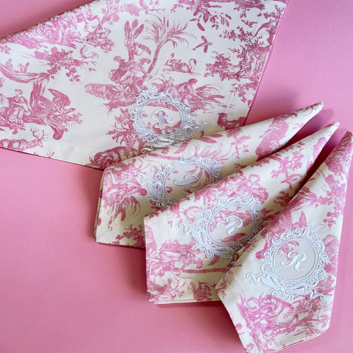 A set of 4 blue Toile de Jouy napkins neatly stacked to show the premium fabric texture.