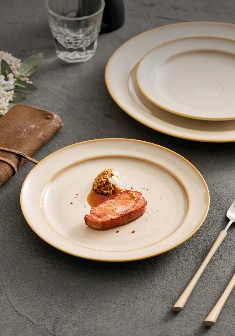 Aerial view of a spiral-motif dinner plate showcasing a golden-accented rim.