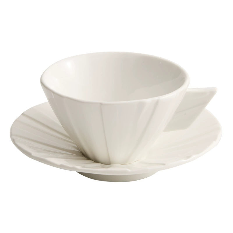 Angular white porcelain cup on matte surface background.