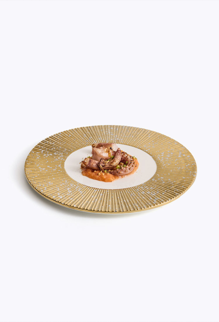 Architectural charger plate with a signature gear-tooth radial rim design.