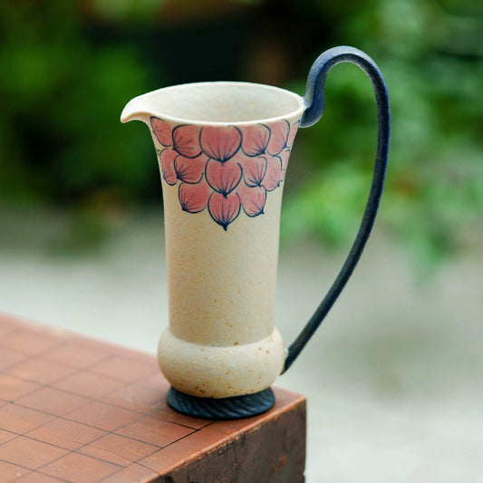 Artisan ceramic milk jug with pink petal pattern