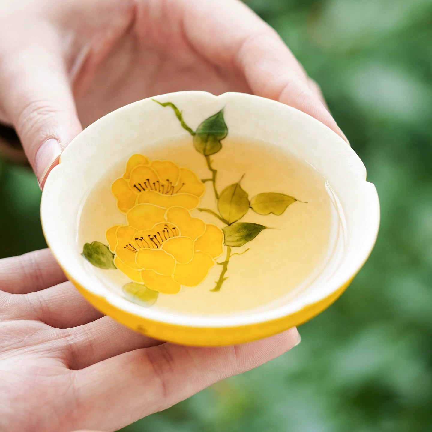 Artisanal conical "douli" tea cup with a decorative scalloped edge.
