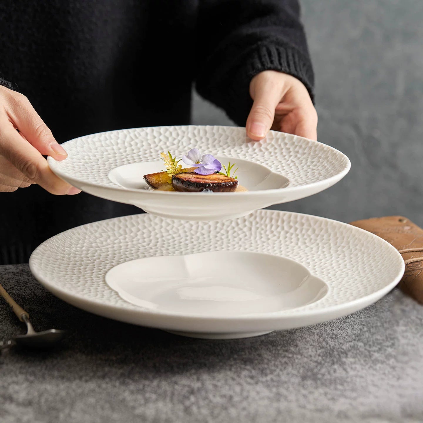 Artisanal deep-dish porcelain plate with a sculptural petal motif.