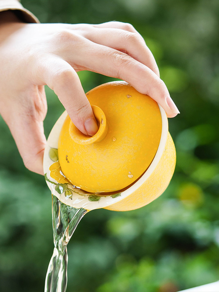 Artisanal yellow porcelain gaiwan with a 4.3cm base diameter for stability and heat retention.