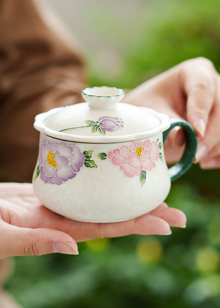 Artistic ceramic tea cup featuring hand-painted blossoms