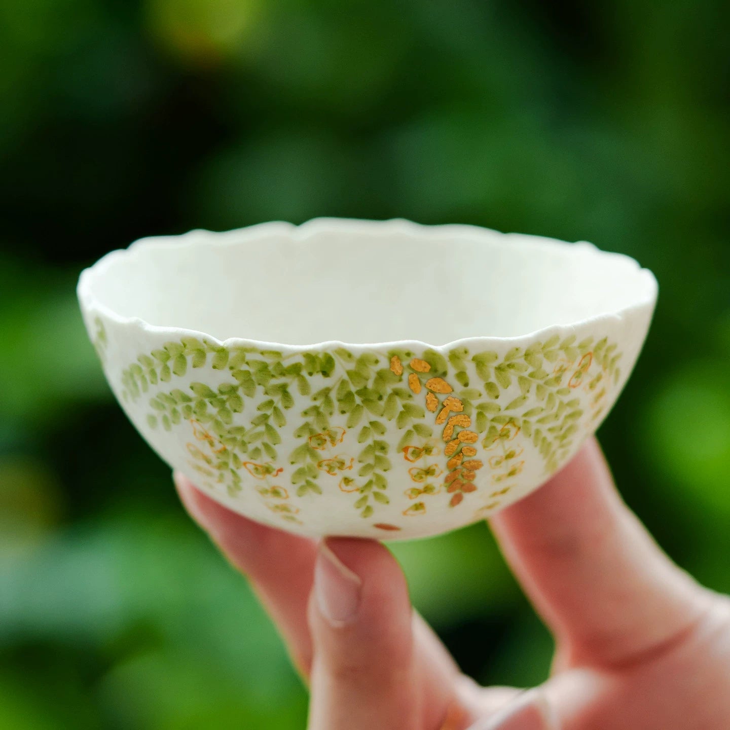 Artistic ceramic teacup with cascading leaves