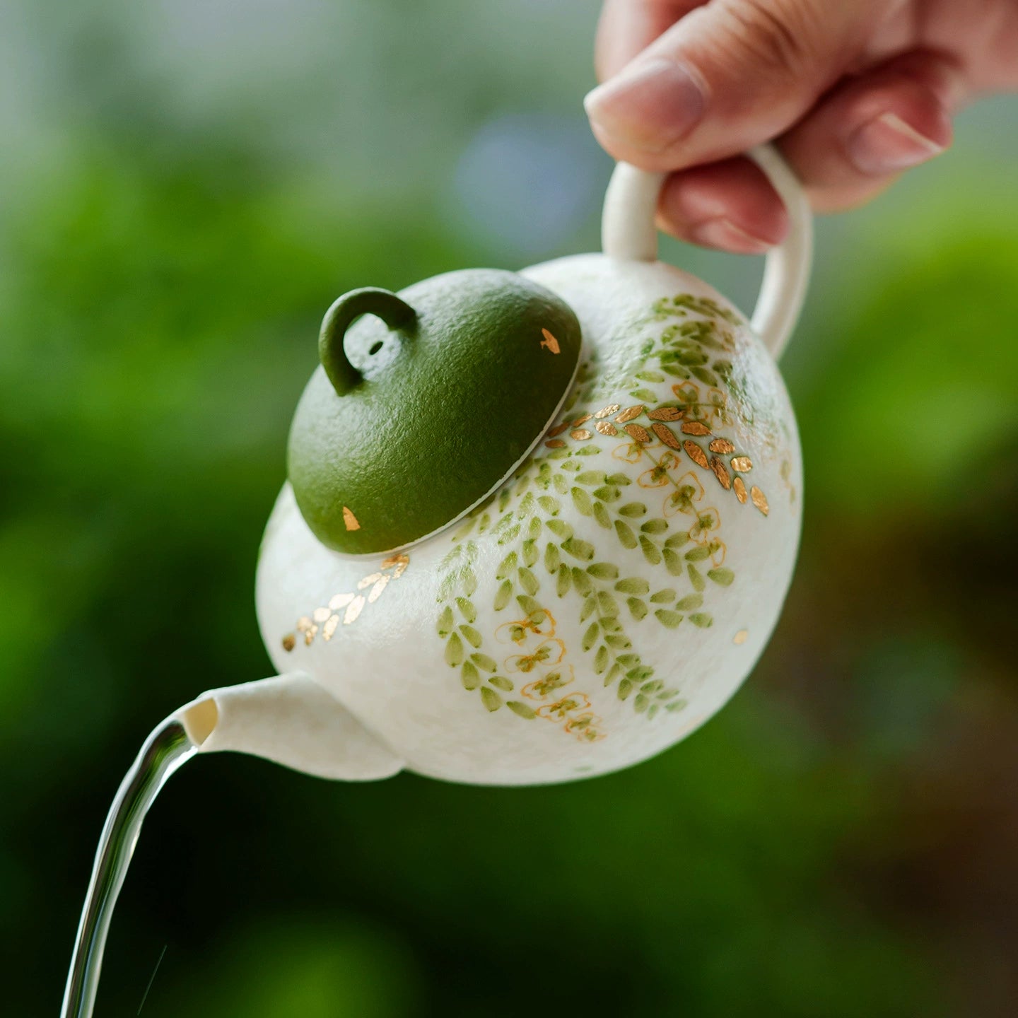Artistic ceramic teapot with cascading leaves