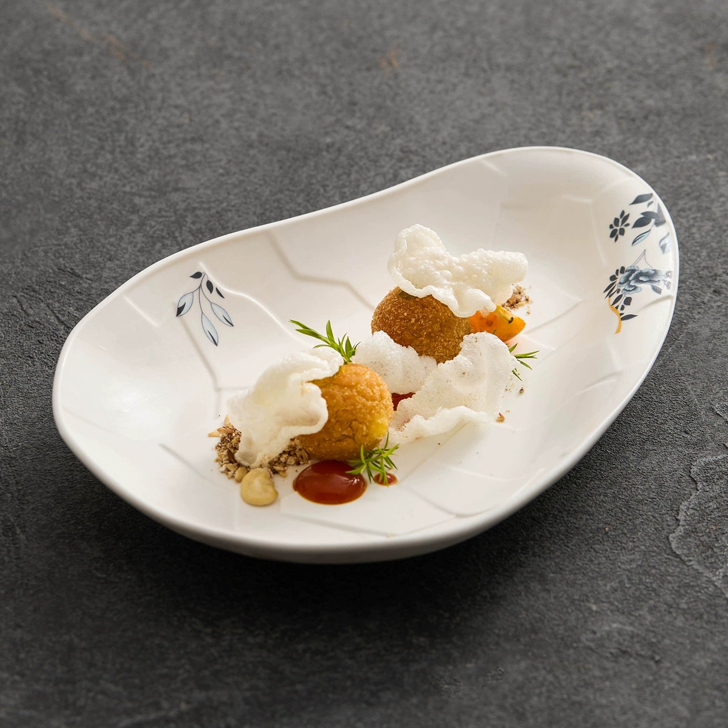 Artistic irregular porcelain plate for modern food presentation.