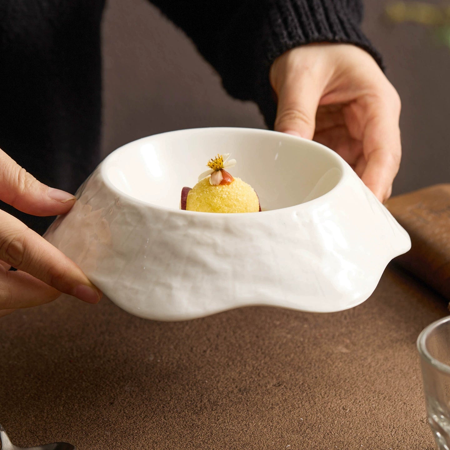 Artistic plating bowl with sculptural contours and smooth interior glaze