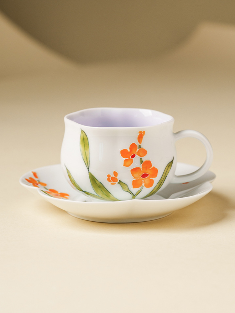 Artistic porcelain teacup with orange flower relief design