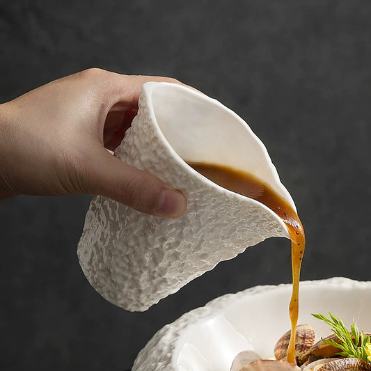 Artistic pouring jug for gravy or soup in modern dining

